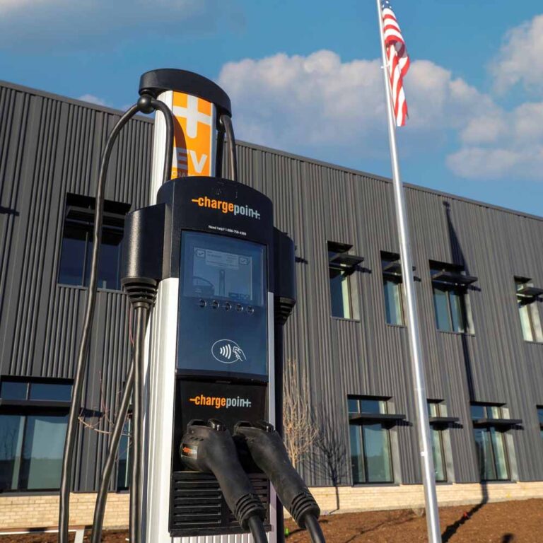Technician installing a Tesla Wall Connector for EV charging at a home in Colorado